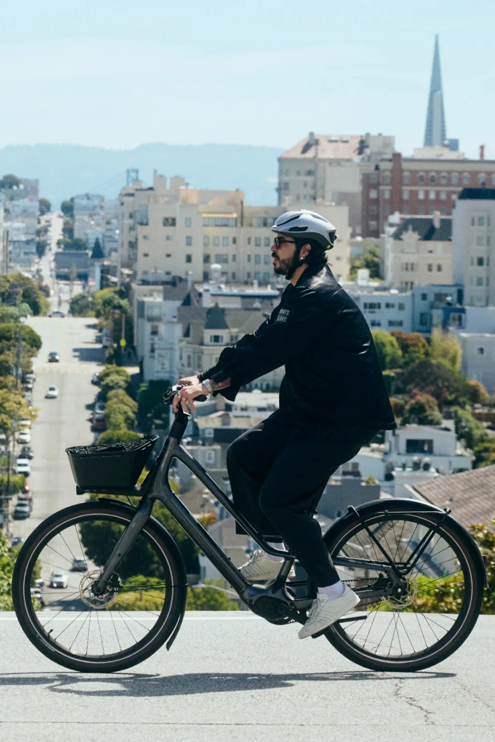 Rider on a city bike above San Francisco wearing Lumos Aero GT in White